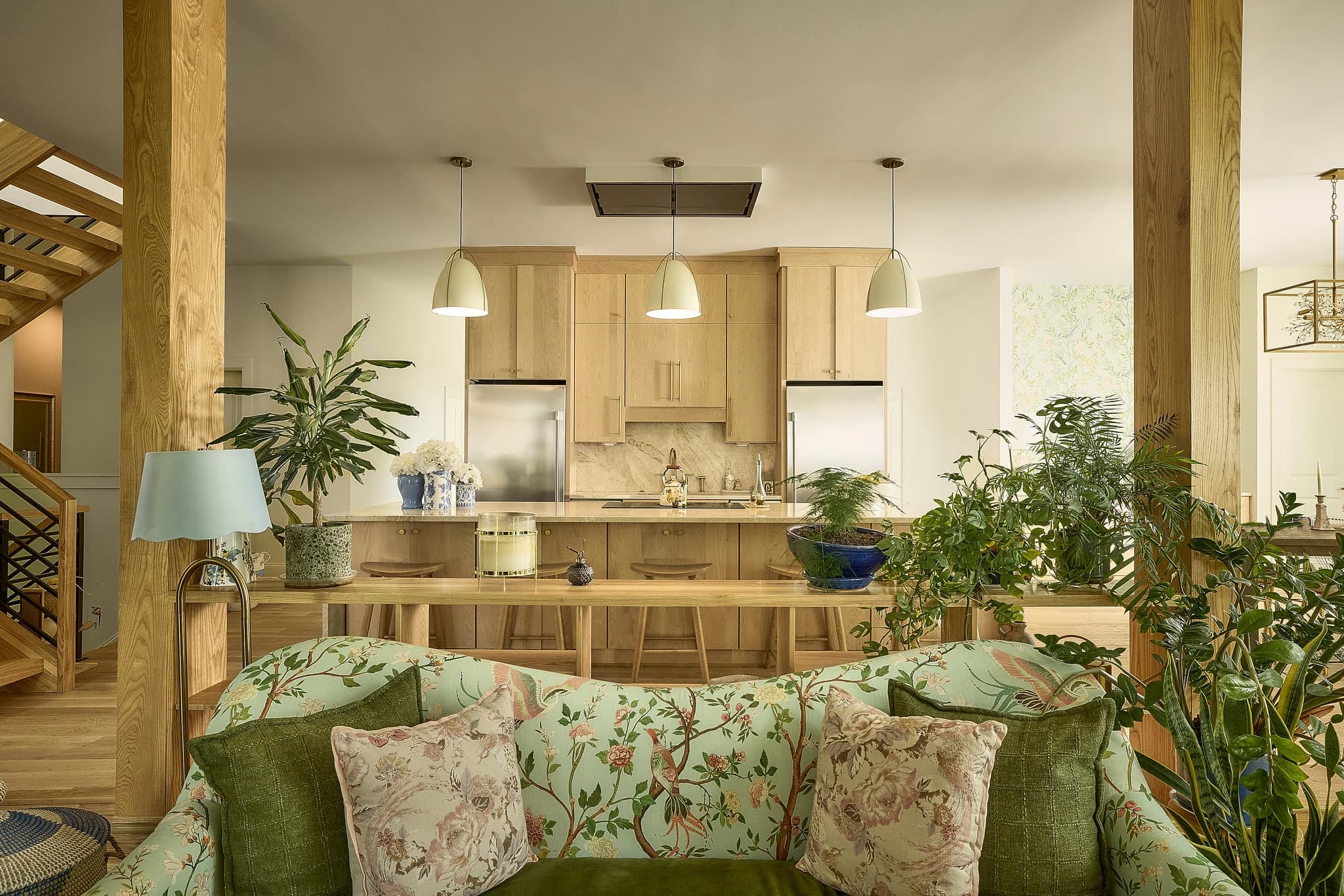Open-concept custom kitchen and living space with natural wood cabinetry in a Meridian-Kessler home.