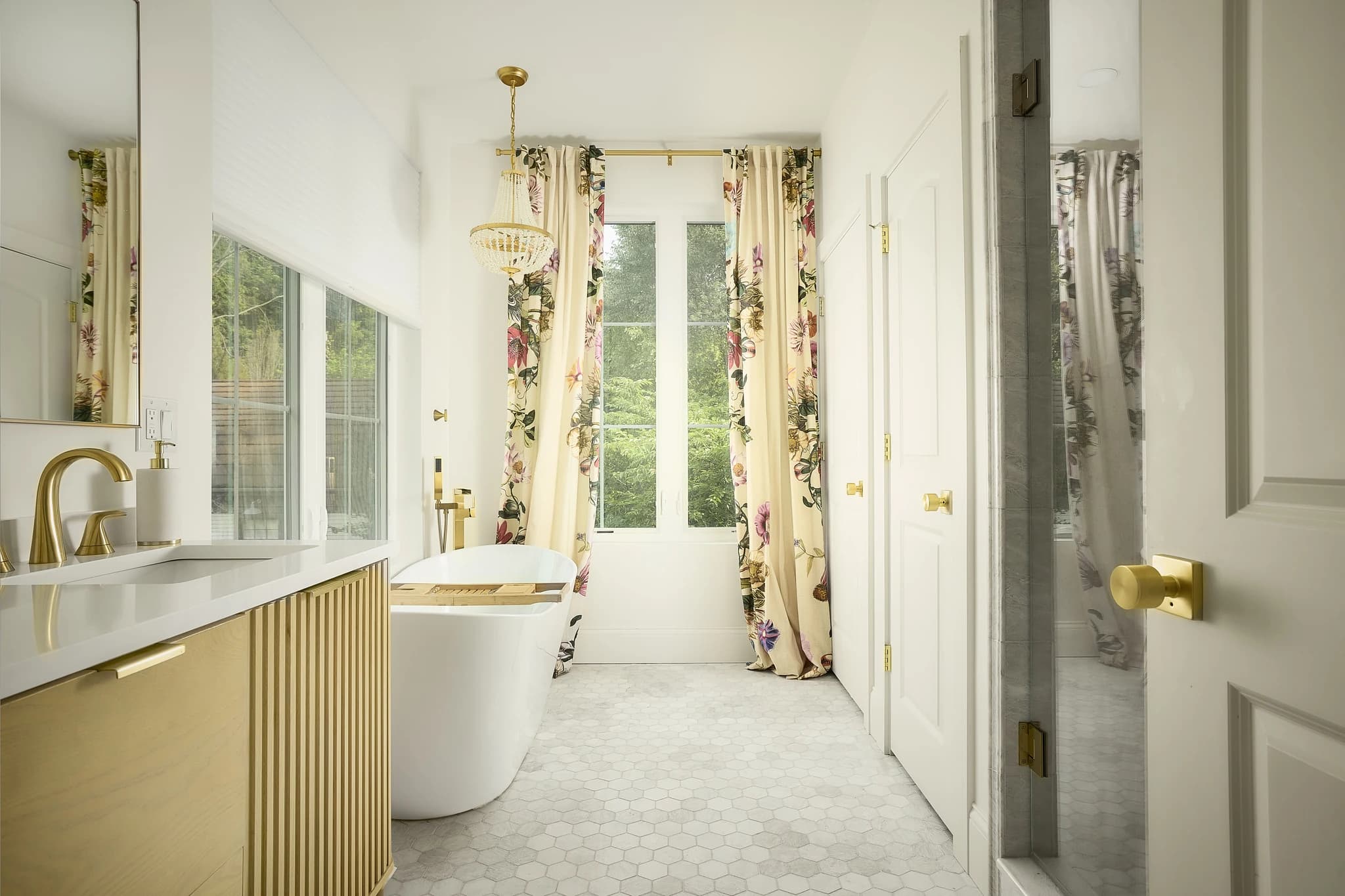 Primary bathroom suite with a freestanding tub and custom fluted-wood vanity in Meridian-Kessler.